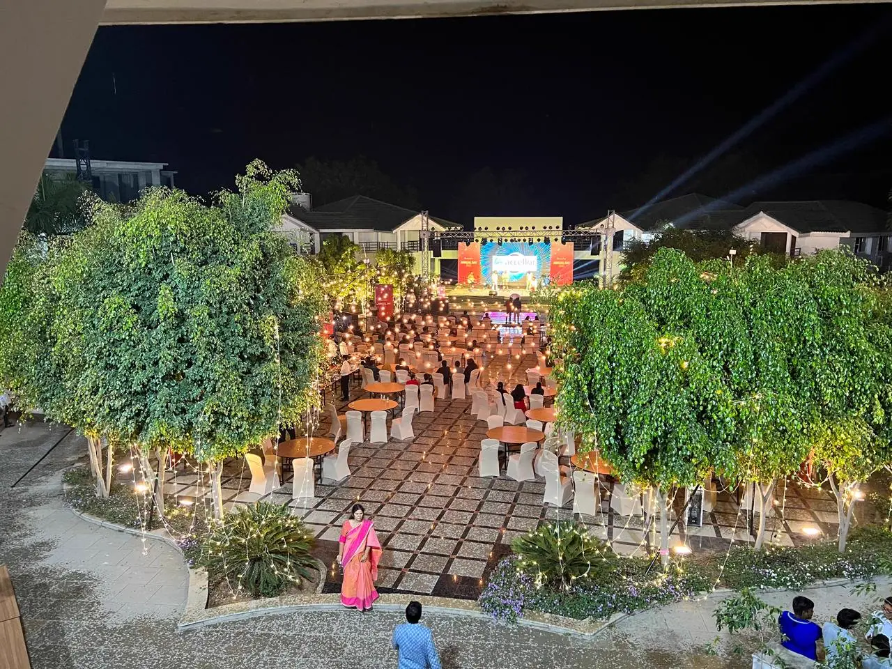 A company evening event on a lit garden stage
