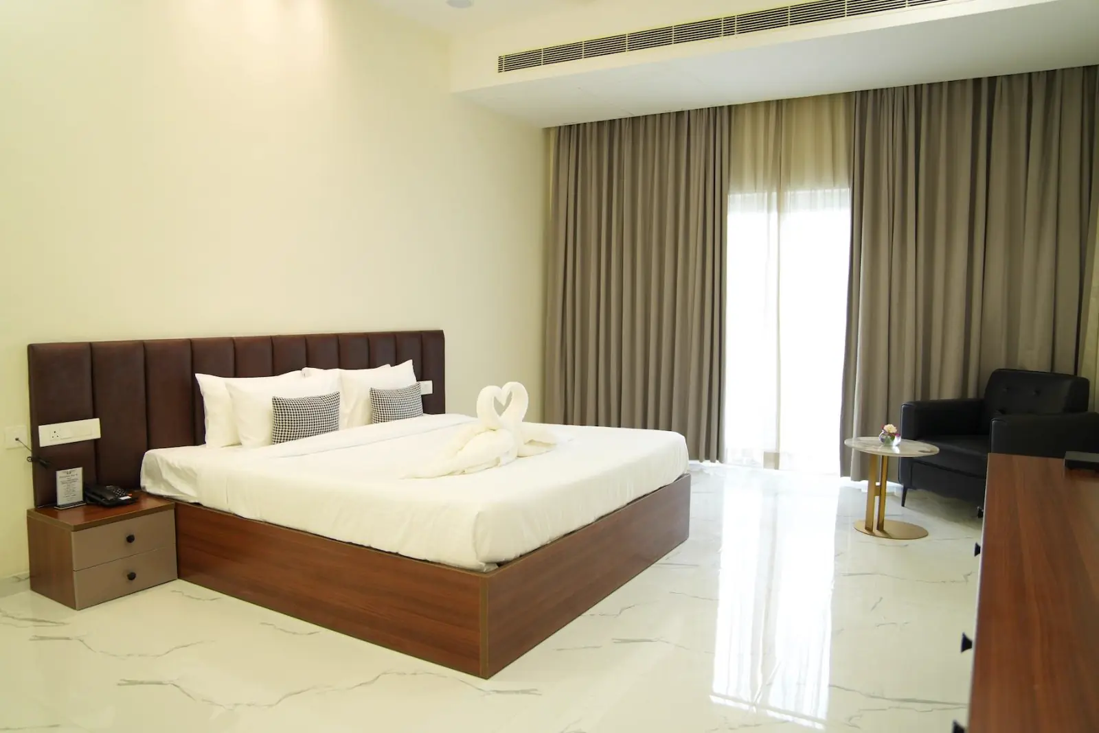 A guest room with a king bed and a window onto the gardens
