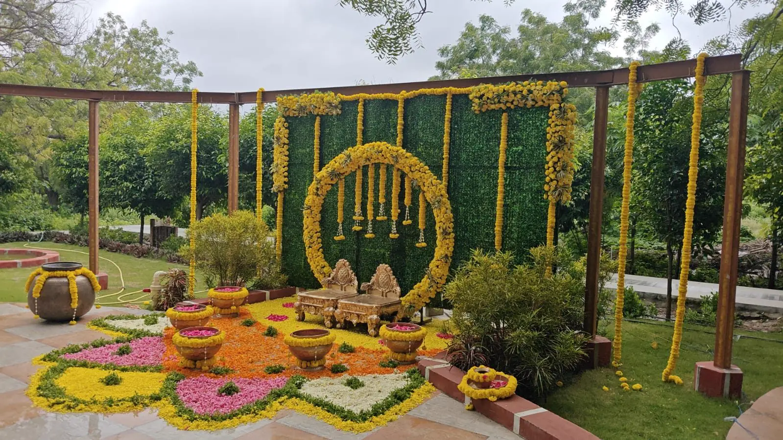 A haldi on the lawn framed in marigolds
